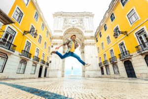 Happy tourist visiting Commerce Square with Rua Augusta Arch in Lisbon, Portugal